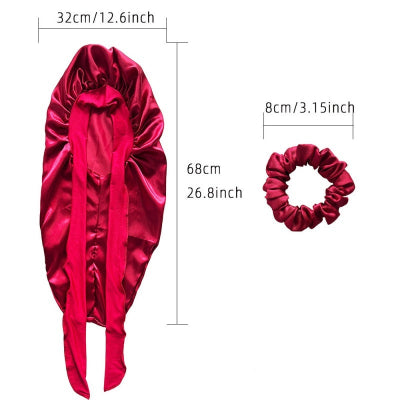 A red satin hair scrunchie and matching hair wrap shown with dimension labels on a white background. The main item is a gathered scrunchie with long ties, and a smaller inset shows a separate matching scrunchie with size annotations.